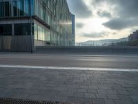 the road is empty on this busy street with the tall building in the background for pedestrians