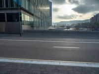 the road is empty on this busy street with the tall building in the background for pedestrians