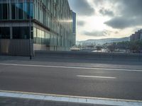 the road is empty on this busy street with the tall building in the background for pedestrians