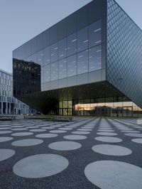 the inside of an office building with large windows and circular spots on a concrete surface