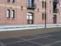 a man is riding a skateboard in the street near some buildings, as if he is going for an urban road