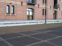 a man is riding a skateboard in the street near some buildings, as if he is going for an urban road