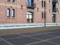 a man is riding a skateboard in the street near some buildings, as if he is going for an urban road