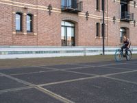 a man is riding a skateboard in the street near some buildings, as if he is going for an urban road