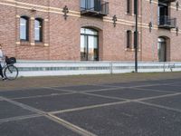 a man is riding a skateboard in the street near some buildings, as if he is going for an urban road