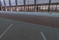 a large building with several glass windows and some lights above it with one light on in the middle