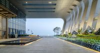 a walkway leads to the entrance of a modern office building in vietnam with low lights