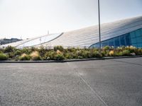 a very long building with a roof that looks like it's made from glass