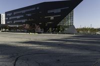 a building with a huge black building in it's center surrounded by several trees