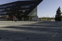 a building with a huge black building in it's center surrounded by several trees