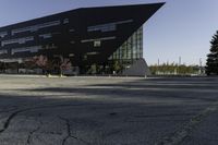 a building with a huge black building in it's center surrounded by several trees