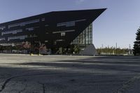 a building with a huge black building in it's center surrounded by several trees