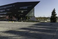 a building with a huge black building in it's center surrounded by several trees