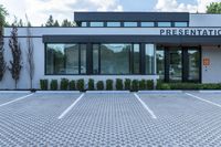 the front entrance to a large business building with an office sign on it's facade