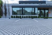 the front entrance to a large business building with an office sign on it's facade