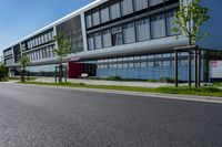 an empty street and an office building in the distance on a clear day in europe