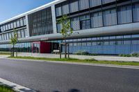 an empty street and an office building in the distance on a clear day in europe