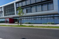 an empty street and an office building in the distance on a clear day in europe