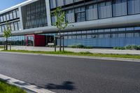 an empty street and an office building in the distance on a clear day in europe