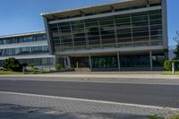 an empty street and an office building in the distance on a clear day in europe