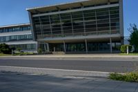 an empty street and an office building in the distance on a clear day in europe