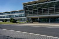 an empty street and an office building in the distance on a clear day in europe