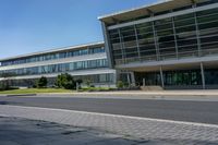 an empty street and an office building in the distance on a clear day in europe