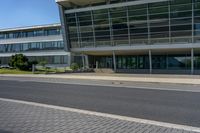 an empty street and an office building in the distance on a clear day in europe