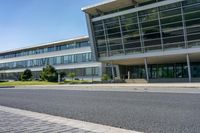 an empty street and an office building in the distance on a clear day in europe