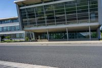 an empty street and an office building in the distance on a clear day in europe