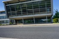 an empty street and an office building in the distance on a clear day in europe