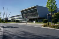 an empty street and an office building in the distance on a clear day in europe