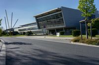 an empty street and an office building in the distance on a clear day in europe