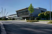 an empty street and an office building in the distance on a clear day in europe