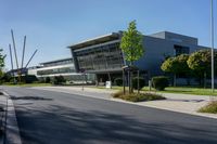 an empty street and an office building in the distance on a clear day in europe