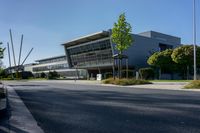 an empty street and an office building in the distance on a clear day in europe