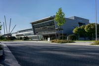 an empty street and an office building in the distance on a clear day in europe