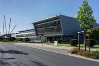 an empty street and an office building in the distance on a clear day in europe