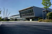 an empty street and an office building in the distance on a clear day in europe