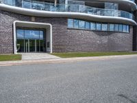 the side of the building has glass windows with curved edges and concrete floors that give it a modern appearance