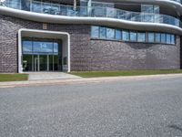 the side of the building has glass windows with curved edges and concrete floors that give it a modern appearance