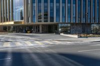 an image of a business building on the corner of a street where there are two traffic lights