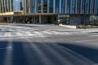 an image of a business building on the corner of a street where there are two traffic lights