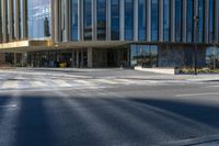 an image of a business building on the corner of a street where there are two traffic lights