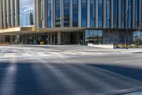 an image of a business building on the corner of a street where there are two traffic lights