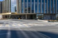 an image of a business building on the corner of a street where there are two traffic lights