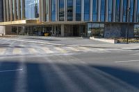 an image of a business building on the corner of a street where there are two traffic lights