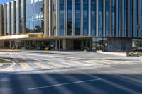 an image of a business building on the corner of a street where there are two traffic lights