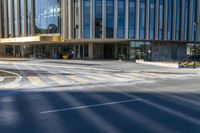 an image of a business building on the corner of a street where there are two traffic lights