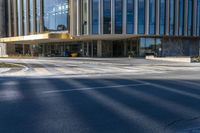 an image of a business building on the corner of a street where there are two traffic lights